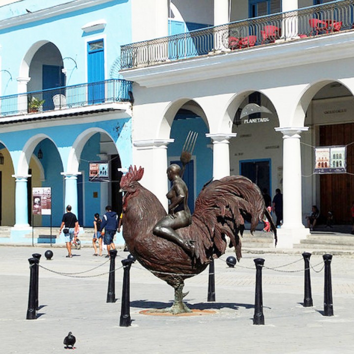 Woman sitting on a rooster at Plaza vieja, Havana Cuba image
