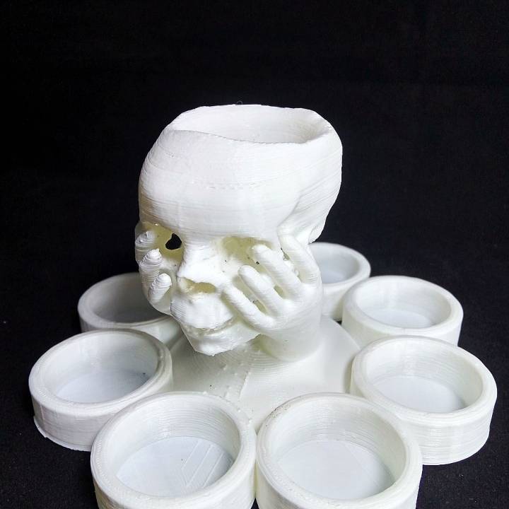 Skull in hand candle holder image