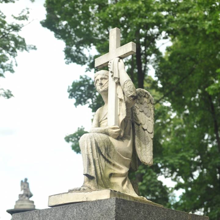Gravestone Depicting Angel Holding the Cross image