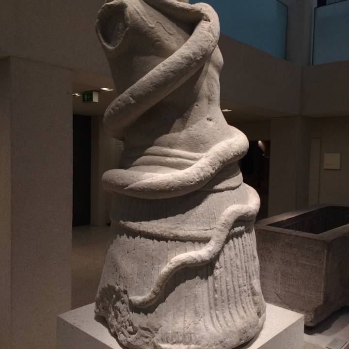Fragment of a statue with a snake image