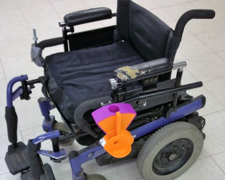 Wheelchair-Mounted Dog Treat Dispenser image