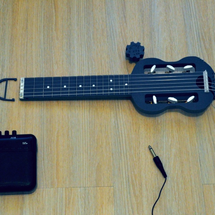 Mini electric guitar for travel. image