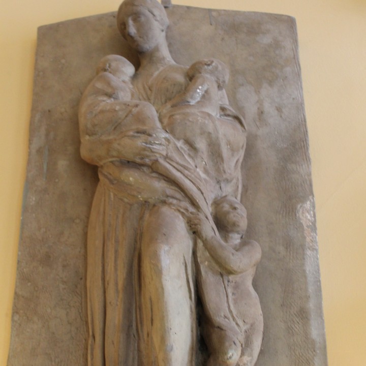 Relief of a woman holding children image