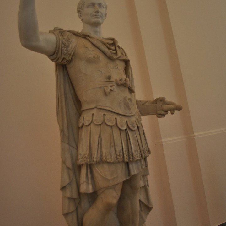Figure in military uniform, with a modern head of Julius Caesar image
