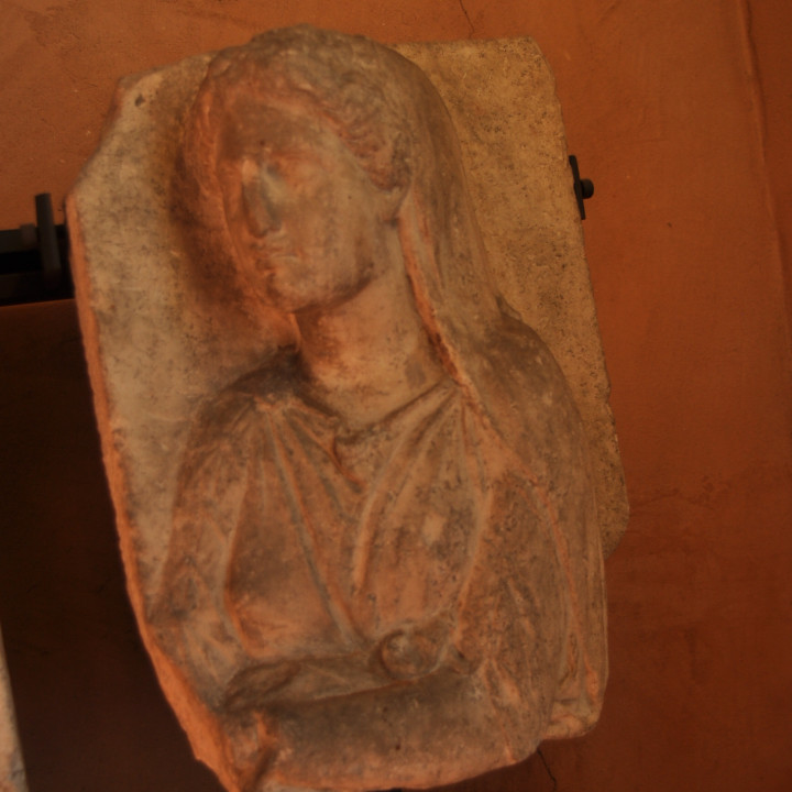 Part of a figurative funerary stele with torso of a woman image